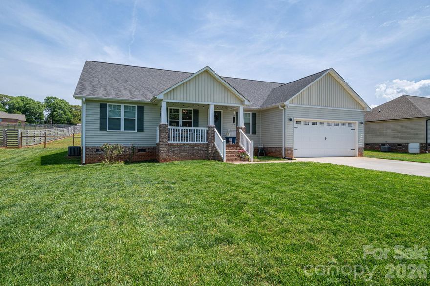 Welcome to Farm house style on a spacious 3/4 of an acre in sought after western Lincoln County! As you walk-in the front door you can't help but feel the warmth of the beautiful dark luxury vinyl plank flooring which is perfectly balanced with light colored walls, shiplap accents, white kitchen backsplash and counter tops and white shaker kitchen cabinets.  The living room boasts vaulted ceilings which makes your open Kitchen-Dining-Living area feel plenty spacious for those large family gatherings.  It has a faux fireplace with an electric heater complimentary of the farmhouse vibe.  Also tucked away off of the living room is a small office perfect for working from home!  The split bedroom floor plan allows privacy for all and even would be perfect for multigenerational living.  A bathroom accommodates both bedrooms on that side of the house and a beautiful barndoor has been installed to close off the entire left side of the house if desired.  Entering from the two car attached garage with an attic pull down you will find a lovely mud room/laundry room where you can drop the dirty shoes before entering your quaint home.  Off the dining room you can head out back to your large deck and enjoy the privacy of a fenced back yard.  If you have ever dreamed of having your own fresh eggs, this could be the perfect place for you as the chicken coops and chickens are negotiable!  The hardest part is getting started and here you can walk right into collecting your own fresh eggs.  As is if this isn't ideal enough, all appliances convey as well, even the washer and dryer!  Don't wait to schedule your appointment to see this home!