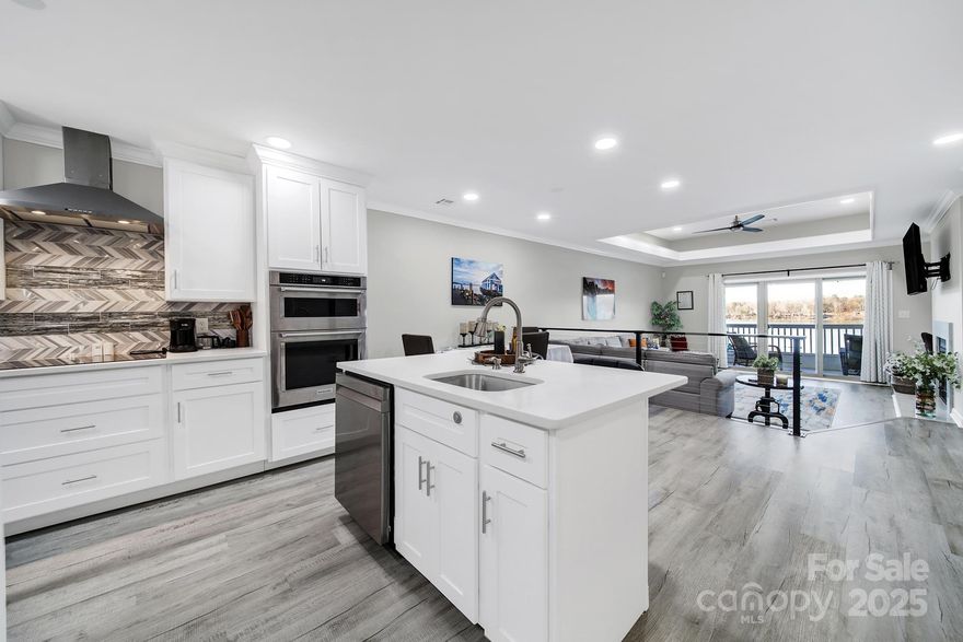 Priced below appraisal! Recently upgraded custom condominium located on the third floor on Lake Wylie, offering breathtaking water views from nearly every room. Located in a quiet yet vibrant community, the property offers easy access to outlet shopping, major highways, and Charlotte Douglas International Airport. The kitchen features a Bluetooth-enabled cooktop, custom island ideal for entertaining, detailed tile work, and stainless steel appliances. White marble flooring throughout creates a modern yet inviting atmosphere. A contemporary divider railing leads from the kitchen down to the living room and out to the balcony overlooking the lake. Additional highlights include a wood-burning fireplace, custom built-in desk, and custom primary closet. Both bathrooms feature LED mirrors. Unwind in the spa-like primary bathroom with a freestanding soaking tub and seated shower with three shower heads, including a rainfall feature. All appliances convey. Move in now and be ready to enjoy lake living this spring!   Schedule your showing today!