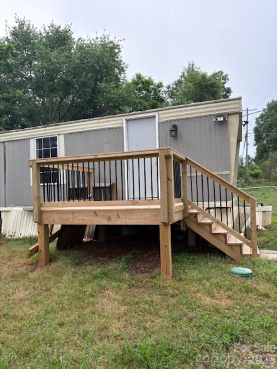 This single-wide home, is located in a quiet neighborhood on a corner lot and features several modern updates, including new sheetrock and vinyl flooring throughout. Additionally, it includes a brand-new deck at the front entrance for you to enjoy. It contains 2 bedrooms and 1 bathroom. Whether you're looking to invest or make it your forever home, this property has incredible potential. Home offers comfort, convenience, and a prime location to downtown Gastonia.
Mini split AC/Heat unit has not been tested.