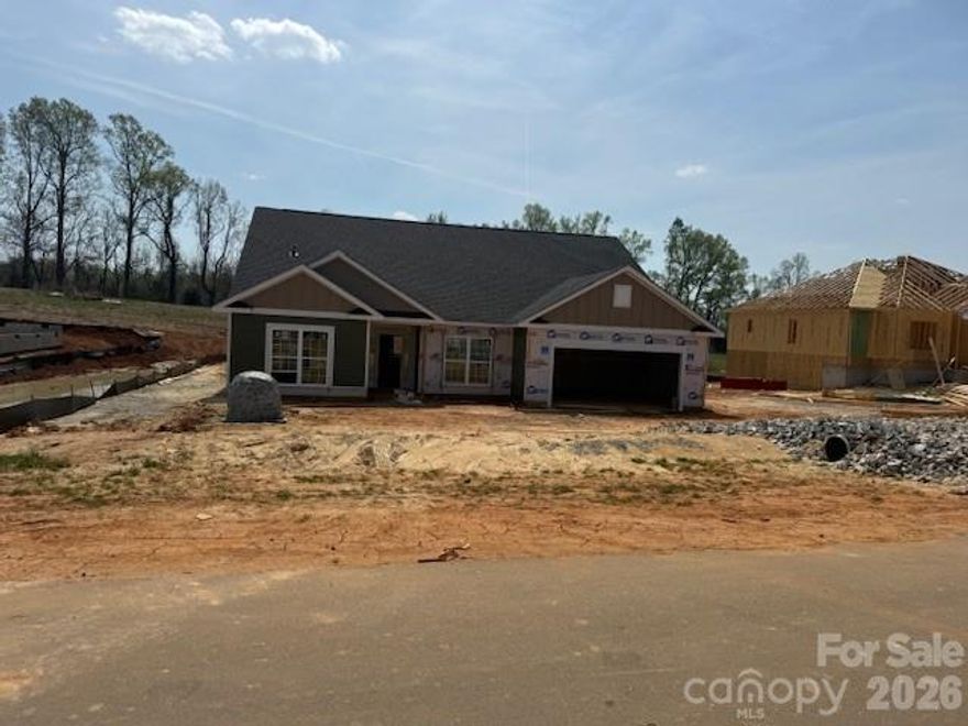 Only $1,000 down to write a contract! This brand-new construction home is situated on .98 acres in the new McNeely Farms subdivision in Mt. Ulla, NC. Conveniently located just minutes from downtown Mooresville, shopping, dining, and interstates 77 and 85.The 3,327 sq. ft. ranch with 4 bedrooms and an office and 3.5 bathrooms offers, 3 bedrooms, a flex space/office and 2.5 baths on the main level. The second floor includes a large bonus room, full bath, and a bedroom. The open-concept floor plan is designed for functionality and entertaining. Interior features include 9' ceilings, a spacious eat-in kitchen with oversized island, quartz countertops, tiled backsplash, gourmet stainless steel appliance package, and laminate wood flooring in the main living areas. The primary suite includes a 5' tiled shower. Exterior features include a 16’ x 14’ covered patio overlooking a large, level backyard in a peaceful setting, Hardie board siding and upgraded stone package. No HOA fees!  Standard closing costs paid with use of one of our 4 preferred lenders and an additional $5K flex cash is available to use towards rate buydown and pre-paids.
All photos are for representation purposes only