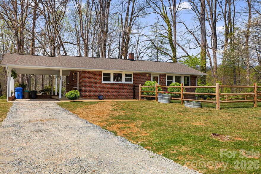 Tucked just outside of town in an established neighborhood, this beautifully converted 2-bedroom, 2-bath ranch offers a rare blend of convenience and natural charm.

From the moment you arrive, you’re welcomed by a delightful, year-round chorus of birdsong—creating a peaceful, nature-rich setting that’s hard to find. The neighborhood is also known for its unique population of white squirrels, adding a touch of local character.

The property features a large fenced area—perfect for dogs or outdoor entertaining—and extends into a wooded backdrop filled with mature tulip poplar trees. With a little vision, a private walking trail could easily be created right in your own backyard. In the winter months, enjoy seasonal mountain views from behind the home.

You will love the location: just down the street you’ll find a community garden, access to a paved section of the Estatoe Trail, and a local skate park. Despite the serene setting, you’re less than a mile from downtown and close to everyday essentials like gas stations and a hardware store. Plus, a short drive opens up access to numerous hiking trails in the surrounding areas of Pisgah National Forest and Dupont State Forest.