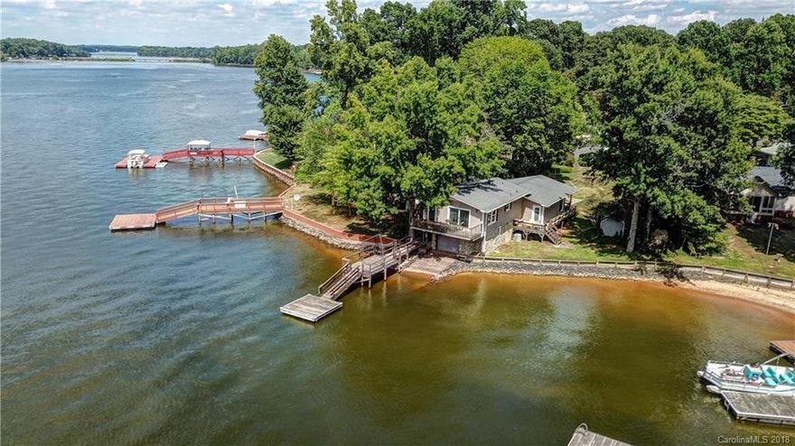 The LAKE VIEWS of High Rock Lake (2nd Largest Lake in NC) are amazing from this 4 bedroom, 3 bath open floor plan home. Not only do you have spectacular views, but this home has a boat house with ramp and comes completely furnished and storage building, this is a great turn-key deal. Property also has a working water fountain surrounded by an outdoor sitting area. You have access to the main channel of High Rock Lake and just minutes to Tamarac Marina&Restaurant. This home will not last long.If you are looking for a permanent residence or just someplace to escape to on the weekends, you need to check out this property.