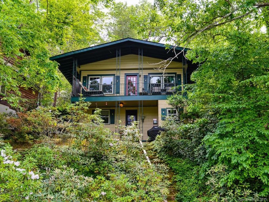 LAKEFRONT cottage has fantastic mountain views with easy access. 100 feet of waterfront with poured concrete seawall. Boathouse with upper deck on deep water. Loads of updates include granite countertops, new cabinet fronts, new SS oven/range.  Quartz vanity in bathroom. Pretty new lead glass front door.  Very well maintained.  Looking for investment income? Ask about the great rental history.