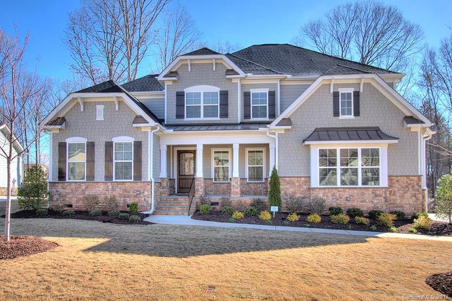 Gleaming hardwoods in DR, foyer, office,  kitchen, breakfast, butlers pantry, and drop zone. Guest suite on main. Tile floors in baths & laundry. Upgraded cabinets/backsplash in kitchen and baths. Stacked cabs, pot filler, upgraded granite, gas stove, expansive island in kitchen. Access to laundry from master closet. 5 full baths! Upgrades galore! (See special features pages.) Blinds in all windows. Private yd backing to woods. Lot located near cul-de-sac. SC schools and taxes! See virtual tour!