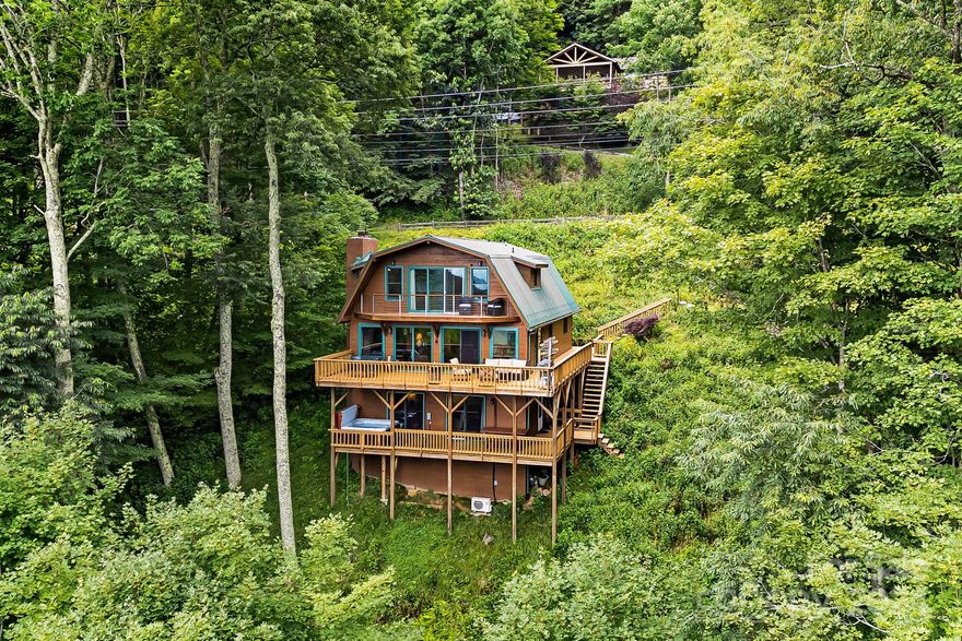 High elevation, well maintained, and updated mountain home with wrap around deck, and nice Southwest Mtn views. Open floor plan with 3 level living with many upgrades. Kitchen w/ stainless appliances, granite counters and a island for meal prep. Bedroom/Bonus on main level, GRM with stone fplc /gas logs and wood floors open up to large deck and views. Upper-level primary w/private balcony, bath with soaking tub and custom shower. 2 additional bedrooms on upper-level w/shared jack & jill bath with double sinks and custom shower.  Basement level with family room, built in wet bar and deck access with hot tub that will convey. Mostly furnished home with high elevation and close to Appalachian Trail, National Forest and many amenities. Double lots gives you plenty of elbow room. 

Non brokers must be accompanied for sec gate.  Amenities are not included in HOA fees, but are subject to separate voluntary fees, ski slopes, country club, and Village Club.