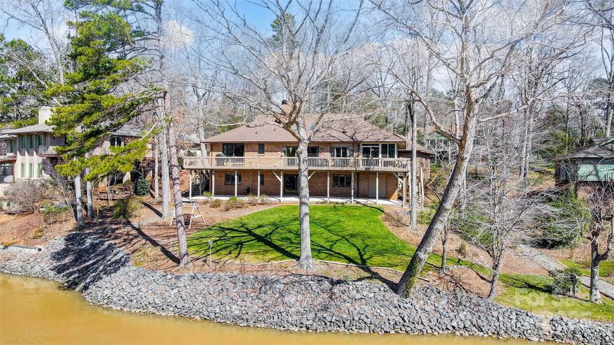 Immerse yourself in glorious long-range views from this waterfront gem, nestled within the gated & amenity-rich community of River Hills. This brick 3BR, 3BA home offers a warm inviting atmosphere & is designed for relaxation w/ beautiful flooring, vaulted ceilings & 2 cozy fireplaces. The kitchen is equipped w/ granite counters, double ovens, breakfast bar, dining area & 2 pantries.  Formal dining room is ideal for elegant dinners or casual get-togethers. Light-filled great room w/ built-in cabinetry & fireplace opens to the expansive outdoor living space. Discover a walkout basement designed for versatility, boasting a rec room w/ wet bar, a flexible bonus space,  generous third bedroom suite, laundry, & plentiful storage. Start your day w/ a cup of coffee in the massive 3-season room. Grill, entertain, and unwind on the deck, enjoying stunning main channel and 18th hole views.  River Hills Country Club available w/ separate membership offering Golf, tennis, pickle ball & 2 pools.