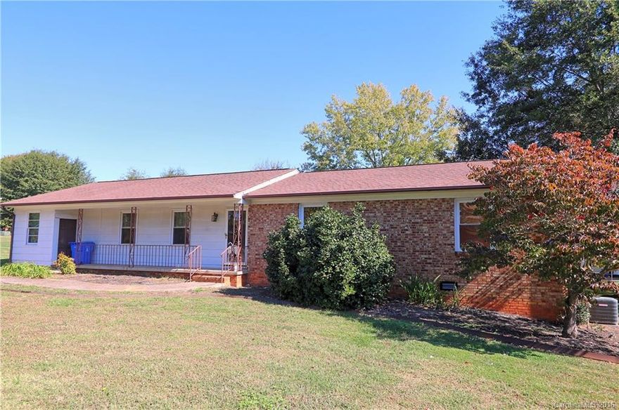 Handyman Special! Charming Brick Ranch with lots of Potential! Home Features 3BR/2BA, Newer Roof and HVAC System, Large Living Room, Family Room w/Brick Fireplace, Hardwood, Carpet and Vinyl Floors, Enclosed 320' Carport, Large Front Porch, Private Wood Deck, Stove, Oven and Dishwasher Remain and Large 24'x28' Detached Storage Building. Priced below market. Great Location near Country Club.