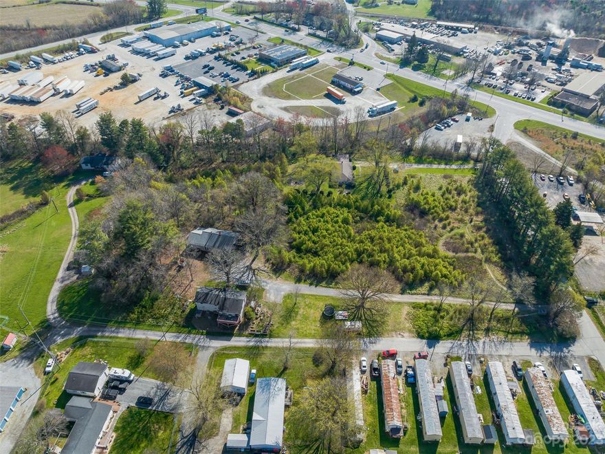 Investment opportunity! Approx. 5.082+/- acres conveniently located 1.1 miles from I-26, midway between Asheville & Hendersonville. Property boasts Local Commercial (LC) zoning, easy access and ample area for increasing density right off heavily trafficked Hendersonville Rd. with 22,000 VPD. Parcel has 3 structures with no value added and currently used as long-term residential rentals. The current leases expire this summer and will be going month-to-month. The area is home to some of the premier manufacturing and industrial facilities of the Southeast and is surrounded by numerous industrial national tenants & employers including Southern Concrete Materials, Meritor & Genette Lumber Company. Inquire with the listing agent for details.  See MLS # 4016413.