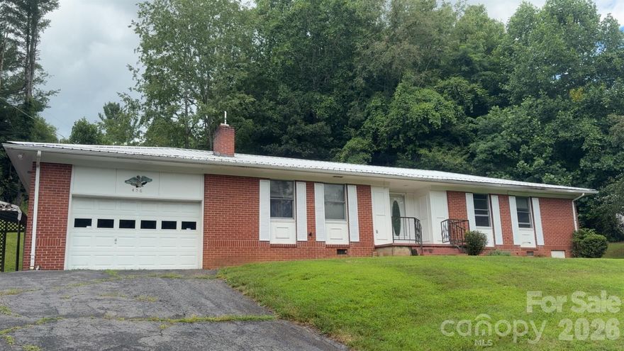 ALL NEW CARPET and FLOORING throughout!! Also, water lines have be repalaced and new well pump installed.This Ranch style home is in a great location on Duck Branch, just outside of Bakersville. 1544 Sqft that has been opened up with a kitchen/dining area, as well as 3 bedrooms and 2 full bathrooms. The attached garage has plenty of space to park a vehicle as well as cabinet space for storage. The outside has a covered back area with beautiful trees and a nice grassy hill that used to be a garden spot. The front of the house is well above the road and has a nice view.