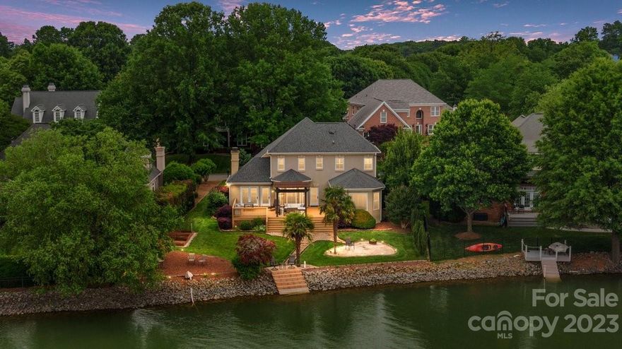 Nestled on the waterfront of LKN, this exquisite 3-BDRM, 2.5-bath radiates luxury. With a modern design & open concept layout, this is primed for entertaining! The chef kitchen boasts S/S appliances, a built-in Oven & quartz counters – presents a culinary haven overlooking the large room. Soaked in natural light, the rear of the home unveils breathtaking views of LKN. The HUGE first-floor primary suite offers a modern en-suite bath, an oversized walk-in shower, huge walk-in closet, & 1st floor laundry. Venture upstairs to discover 2 more bedrooms & a bonus room, acting as a functional 4th bedroom. The outdoor living offers an oversized deck that gradually descends to a private palm-saddled white sand beach area. With ~70ft of water frontage and a meticulously curated landscape, this backyard is a veritable paradise. Boat slip #8 included! Major upgrades include: Crawl space encapsulation:(‘22); Entire house duct work (’23), 2nd floor HVAC (’21); Interior / deck painted (’23) & more