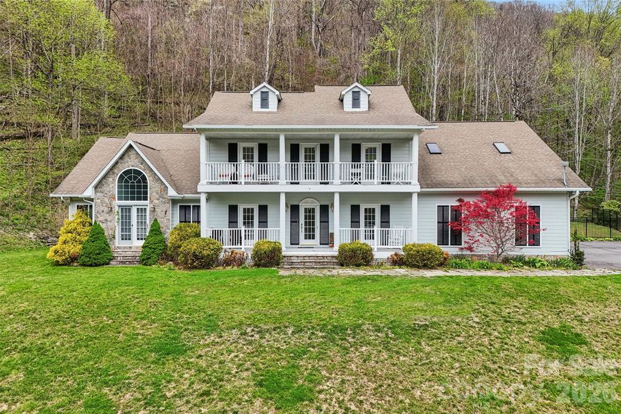 Love the mountains? Then, this stunning Maggie Valley home is for you!  It checks a lot of boxes -- privacy, mountain view, porches, decks, patio, fenced yard, ample parking, proximity, space and elegance -- we could go on.  Relax and feel the cool mountain breeze while you have your morning coffee or evening drink on the front porch.  Spacious accommodations include four bedrooms, two dining areas, two full baths, and two half baths.  Brazilian hardwood provides a classy elegance and warmth to the entire main floor.  Inset cabinets, bookshelves, device nooks, and even ceilings, display the quality craftsmanship that makes this place special.  Have sore muscles?  Enjoy the outside hot tub or the inside jacuzzi.  Planning dinner for a crowd?  Good thing you have two full ovens.  Need places for them to sit?  Choose from a formal dining room, an informal breakfast nook, a couple of seats at the kitchen bar, of plenty of extra seating out back on either the inside screened porch or outside patio and deck.  Need places for them to relax after dinner?  Try the family room or the spacious den, both on the main level, or the large "whatever you want it to be" room on the upper level.  Too many folks to fit on the front porch after all the fun?  No problem -- you have two of them -- one on the main level and a balcony porch running the length of the house on the upper level.  Add in a spacious two-car garage, with extra outside parking, and you really do "have it all".  Come see for yourself!  This home is part of the Fisher Ridge community.