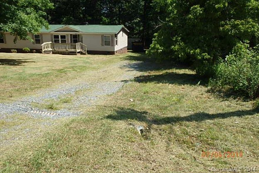 Large doublewide on a private wooded 1 acre lot. Front deck, detached shed. Large kitchen with island. Spacious great room with fireplace. Lots of cabinets.