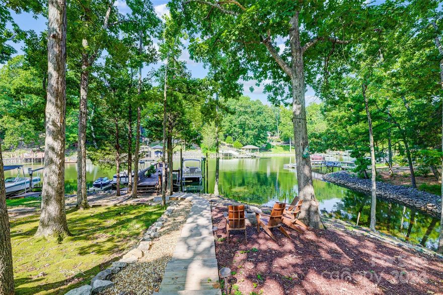 Don't miss this hard to find waterfront home at this price in River Hills, includes dock just steps from the rear patio! Open floor plan, bright & inviting. Spacious great rm with built-in cabinetry & formal dining area. Chef’s kitchen, ss appliances, leathered quartzite counters, dbl ovens, opens to vaulted breakfast rm. Primary suite on main level. Upstairs provides 2 BRs & BA. Lower level boasts a versatile rec rm, perfect for entertaining or using as office, exercise space, media rm, or playroom. New vanities in master & powder rm, New indoor lighting & fans, new paint throughout. Private balcony, where you can enjoy morning coffee, read a book, or relax & soak in the stunning lake views. The covered patio is ideal for grilling & entertaining, floating dock with easy access to boating & watersports. New landscape lights & new walkway to dock. River Hills is a gated community offering a range of amenities. Country Club available w/ separate fees offering golf, tennis, & swimming.