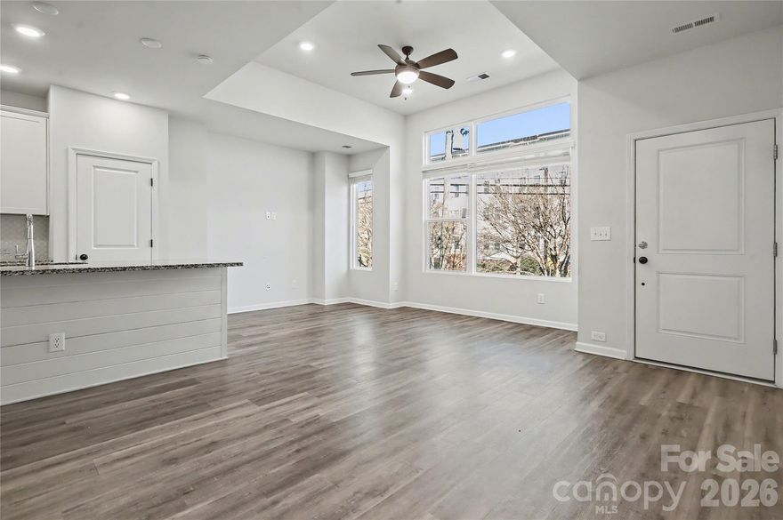 Priced to sell and offering 1% Buyer Credit with preferred lender! Welcome home to this beautiful townhome in highly sought after Brightwalk. Part of the final phase of the neighborhood from David Weekly, this home features great finishes and modern upgrades perfect for a variety of homeowners or investors. From the fenced yard and brick stairway, enter into a spacious open living/dining/kitchen floorplan. Kitchen boasts granite countertops and kitchen island. Main floor leads to powder room and primary bedroom with two walk in closets, full bathroom with dual vanities. Lower level has two ample bedrooms, full bathroom, laundry room, storage and leads into full two car garage. Hardwood floors throughout, all appliances included. Brightwalk is walkable with Anita Stroud Park built into the nieghborhood. Convenient access to I77/I85 Live within walking distance to booming Camp North End, Heist Barrel Arts and a short drive to Uptown, Noda and Plaza Midwood. Don't miss out on this amazing opportunity! Brightwalk has no rental restrictions, property could be used as a short or long term rental!