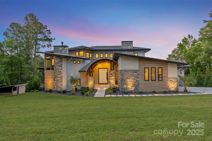 Welcome to this private luxury retreat on the main channel of Lake Wateree! Spanning 6,000 sq. ft. on a 1-acre lot, this architecturally striking modern home offers an exclusive lakefront lifestyle. Inside, you’ll find 5 bedrooms, 5 full baths, and 3 half baths thoughtfully spread across 3 levels. The main level features a chef’s dream kitchen with Thermador appliances, including a double oven & built-in coffee machine. The elegant primary suite features a walk-out balcony, gas fireplace, and spa-style bath with multiple shower heads. The upstairs hosts 2 spacious bedrooms/baths plus a cozy TV nook. The walkout basement offers 2 additional bedrooms, a second full kitchen, an exercise room, and effortless access to the lakefront. Enjoy an indoor + outdoor chef’s kitchen with a Kalamazoo brand grill & cabinet smoker, a hidden speakeasy-style 1,000-bottle wine cellar, an infinity-edge pool/hot tub, theater room, a Full Swing professional golf simulator, & a grilling porch with lake views.