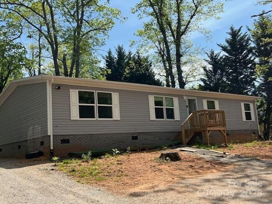 **The seller is willing to buy-down the interest rate for a buyer** Going from today's rate on a 30yr term to 4.5% is a savings of approximately $350 per month. Don't let this one get away!
 Like new Clayton manufactured home with 4-bedrooms and 2-baths.The kitchen island and dining area offer a blend of functionality and style for families. The kitchen island provides extra prep space and seating, while the dining area can be a formal or more casual space. The primary bedroom has an ensuite bath with a large walk-in closet. The other bathroom is centrally located for the other3 bedrooms. This home offers an open floor plan, making it feel spacious and airy.  
* The home is a 23 model but was not completed until 24, the septic was inspected at the time the home was set up however there is nothing showing size with the county. Tax card shows 3 bedroom however all 4 bedrooms have closets.*  The parcel was surveyed before the home was placed. The owner also offers the corner lot with the commercial building which is leased at this time. MLS #4193118.