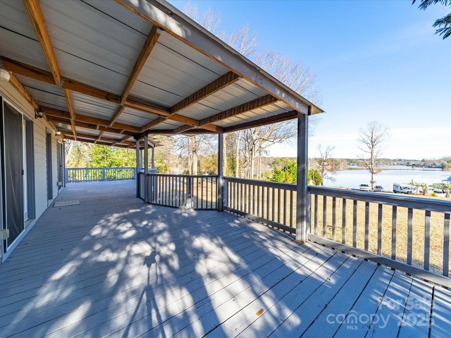 Enjoy lakefront living with this waterfront ranch on Lake Wylie, featuring 127 feet of water frontage on a peninsula along the main channel. Eligible for a dock and offering STR potential, this home is a rare find!

Recent 2024 updates include a new roof, fresh paint, and a new well. Inside, the open living area features a wood-burning fireplace, while the kitchen boasts new LVP flooring and a laundry/pantry room. The primary suite includes an ensuite bath, with two additional bedrooms—one with French doors leading to the deck—and a second full bathroom.

A partially covered wraparound deck offers stunning lake views, perfect for entertaining. The large gravel driveway provides ample parking, and a powered workshop/shed adds extra storage. The home is also wired for a generator for added convenience.

Located just across the water from Tega Cay and Fort Mill, and minutes from I-77, this home blends serenity and accessibility. Don’t miss this incredible lakefront opportunity!
