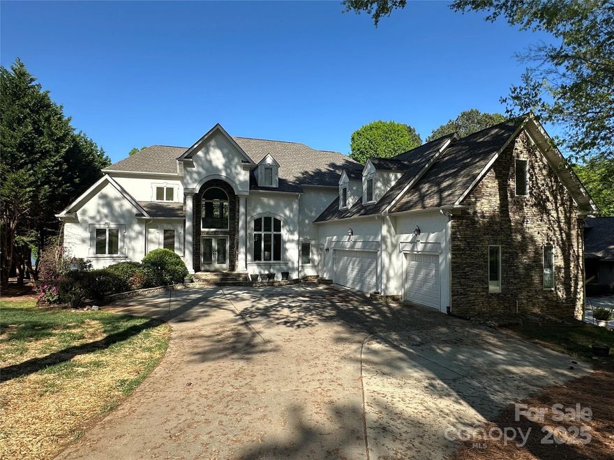 Magnificent custom 3-story waterfront home situated on large 1.6 acre lot with pristine views of Mountain Island Lake located across the lake from Latta Plantation. This lovely home has it all…in ground pool, spa, covered pier, floating dock with covered boat slip, 3 car garage, primary bedroom on main floor, large open concept main floor with fireplace, large primary bathroom with 2 closets, basement perfect for entertaining complete with in-law suite, 2nd kitchen, exercise room, fireplace, walk out access to fenced in in-ground swimming pool. Home was recently painted inside and outside, new roof installed in 2025, hardwood floors recently refinished, new carpet in bedrooms, new recessed lighting throughout, fresh landscaping and more.