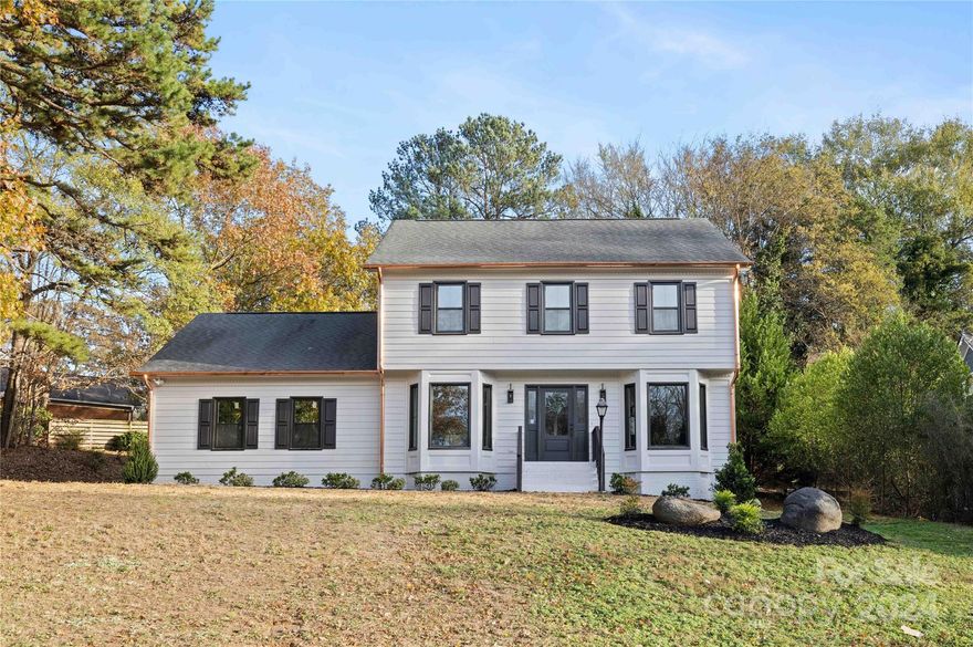 This charming home in South Charlotte has undergone a complete cosmetic overhaul by the Dapper development team. It boasts a fantastic location surrounded by million-dollar homes and is just a stone's throw from Colony Place Shopping Center. As you approach the property, you'll immediately appreciate the thoughtful design featuring brand new bronze windows and stunning copper gutters. Step inside to discover a beautifully renovated kitchen equipped with soft-close shaker cabinets, quartz countertops, a custom tile backsplash, a custom wood hood vent, and stainless steel appliances.The bathrooms have also been completely transformed, showcasing all-new custom tile, vanities, and fixtures. The oversized primary suite and its bathroom are sure to impress. Additional updates include new engineered hardwood floors, fresh paint inside and out, and modern plumbing and electrical fixtures. The property also features a deck out back and a two-car garage, making it an all-around perfect home!
