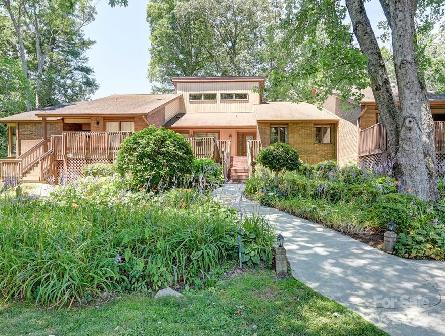 GOLF FRONT CONDO. This home sits on the green of no.7 and the tee box of no.8 at the Etowah Valley Golf and Country Club.  Two beds and two baths on the main level and a second primary suite upstairs, vaulted ceilings in the family room and a large deck in the back overlooking the golf course.  Large stone fireplace, with gas logs and remote start. Newer kitchen cabinets and granite countertops and stainless-steel appliances.  This home has been beautifully updated and includes a detached garage. Primary bedroom faces the golf course and access to the back deck. Large front deck for grilling and entertaining. Just minutes to the golf club, restaurants and shopping, great location just West of Historic Hendersonville and East of Brevard, NC.