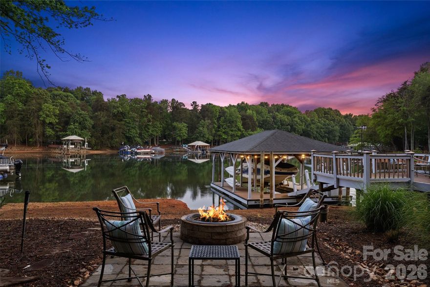 Beautifully renovated waterfront home on Lake Norman offering timeless elegance, thoughtful design, and exceptional indoor outdoor living. Welcoming foyer is flanked by a formal dining room with tray ceiling and detailed moldings and a private study with cathedral ceiling, French doors, and bay window. Rich architectural details including arched entryways and extensive crown molding carry throughout. The chef’s kitchen features quartz countertops, double ovens, pot filler, beverage refrigerator, under cabinet lighting, breakfast nook with lake views, and updated appliances. The great room impresses with a floor to ceiling stacked stone fireplace, custom built ins, surround sound, and a wall of windows overlooking the screened porch with vaulted tongue and groove ceiling. The main level primary suite offers a double tray ceiling and direct access to the screened porch along with a beautifully updated bath with frameless glass shower. Two additional main level bedrooms share a Jack and Jill bath, plus a spacious upper level bonus room, bedroom, full bath, and walk in attic provide flexible living space. Situated on approximately 0.80 acres with a fenced yard, this property features a lakeside fire pit, extensive landscaping with lighting and walkways, irrigation from the lake, and a potting shed workspace. Additional highlights include a three car garage, whole house generator, and two newer hot water tanks. Enjoy 103 feet of shoreline in a deep water cove with a composite floating dock and sitting area, delivering the ultimate Lake Norman waterfront lifestyle. Located in the highly desirable Sailview community, residents enjoy amenities including a lakeside pool with scenic water views, clubhouse, tennis courts, playground, and an active social calendar.