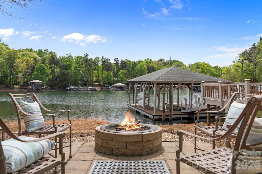 Beautifully renovated waterfront home on Lake Norman offering timeless elegance, thoughtful design, and exceptional indoor outdoor living. Welcoming foyer is flanked by a formal dining room with tray ceiling and detailed moldings and a private study with cathedral ceiling, French doors, and bay window. Rich architectural details including arched entryways and extensive crown molding carry throughout. The chef’s kitchen features quartz countertops, double ovens, pot filler, beverage refrigerator, under cabinet lighting, breakfast nook with lake views, and updated appliances. The great room impresses with a floor to ceiling stacked stone fireplace, custom built ins, surround sound, and a wall of windows overlooking the screened porch with vaulted tongue and groove ceiling. The main level primary suite offers a double tray ceiling and direct access to the screened porch along with a beautifully updated bath with frameless glass shower. Two additional main level bedrooms share a Jack and Jill bath, plus a spacious upper level bonus room, bedroom, full bath, and walk in attic provide flexible living space. Situated on approximately 0.80 acres with a fenced yard, this property features a lakeside fire pit, extensive landscaping with lighting and walkways, irrigation from the lake, and a potting shed workspace. Additional highlights include a three car garage, whole house generator, and two newer hot water tanks. Enjoy 103 feet of shoreline in a deep water cove with a composite floating dock and sitting area, delivering the ultimate Lake Norman waterfront lifestyle. Located in the highly desirable Sailview community, residents enjoy amenities including a lakeside pool with scenic water views, clubhouse, tennis courts, playground, and an active social calendar.
