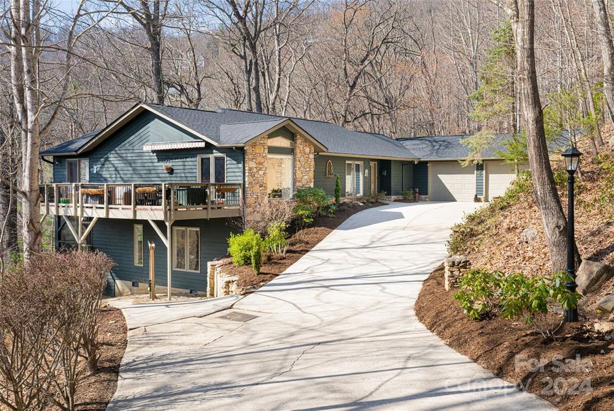 Welcome to a luxurious retreat in the serene enclave of E. Asheville. This exceptional 5 bed/3.5 bath home with meticulously updated interior exudes warmth & sophistication. The centerpiece of the home is the gourmet kitchen, complete with large granite island, butler's pantry, formal dining & sitting room. A spacious living room with vaulted ceilings & sunroom invites you to revel in natural light. Primary suite & ensuite guest bedroom on main are complimented by an updated laundry room, powder room & 2 car garage for fully functional main level living. The lower level offers additional living room with mini-bar, 2 bedrooms, flex/bedroom, full bath, home gym & workshop. Outside, multiple decks provide space to unwind in tranquil ambiance. Explore the private nature trail onsite, or venture out to the renowned MST trail/Blue Ridge Parkway, just steps away along the perimeter of the neighborhood. This home stands as a testament to tranquil, convenient, and amenity rich mountain living.