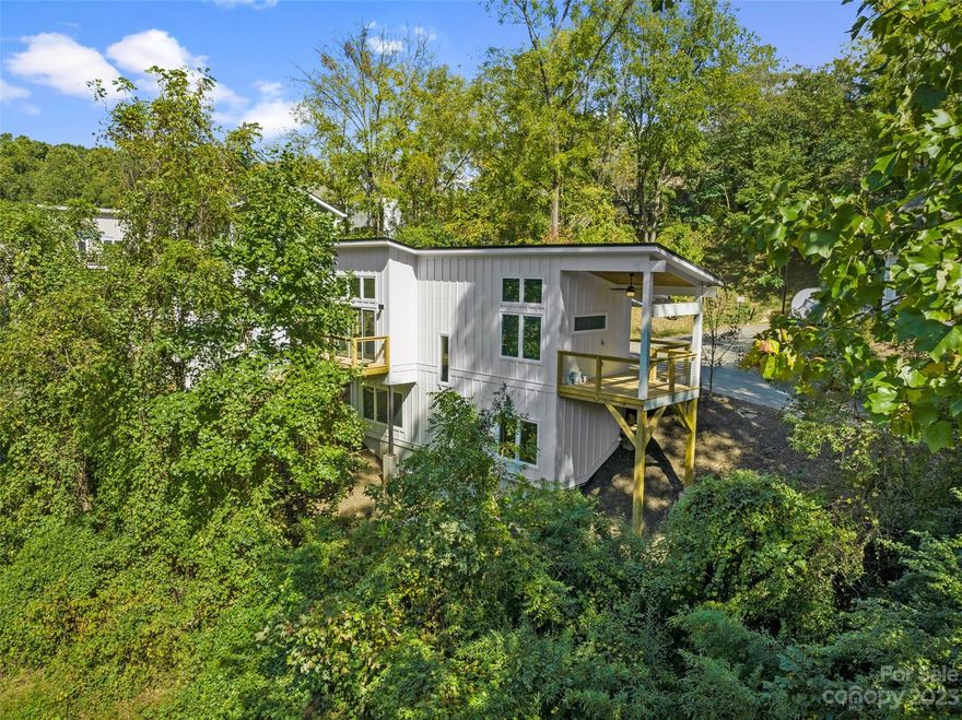 Welcome to your brand new beautiful, modern 3/2( flex space) home in popular West Asheville, NC! This stunning residence boasts modern amenities, stylish finishes and amazing outdoor space. The open-concept living and dining areas are perfect for entertaining. With spacious main level bedroom with vaulted ceiling and great light. Downstairs offers additional bedroom and full bath  laundry and a flex space could be bedroom or office.  Concrete wall feature downstairs is perfect for pilates wall or climbing enthusiast.  Enjoy the beautiful Asheville weather from the comfort of your private outdoor spaces over looking small creek , or take a short walk to explore the River Arts District, Haywood Rd, numerous parks & greenways . This home also offers convenient access to major highways & public transportation, making it the perfect place to call home. Don't miss out on this incredible opportunity to own a new home in one of the most sought-after neighborhoods in the area!