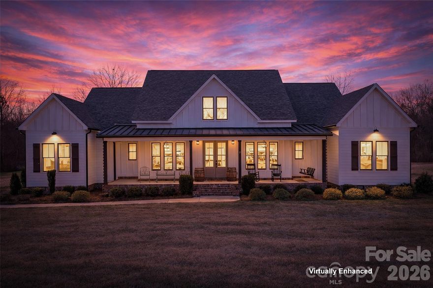 Exquisite Luxury Custom-Built Residence in the Highly Coveted North Lincoln School District

Welcome to a home where exceptional craftsmanship, thoughtful design, and modern comfort blend seamlessly. Built in 2021, this refined farmhouse-style residence features beautifully exposed beams in the vaulted living and dining areas, an elegant accent wall in the home office, White Oak 3/4" hardwood flooring throughout the main level, quartz countertops, and a meticulously curated open-concept layout.

The main level showcases four bedrooms, including an impressive primary suite enhanced by its own dedicated HVAC system for personalized comfort. A sophisticated split-floor plan provides three additional bedrooms, two full baths, and a stylish half bath—offering both functionality and elevated design.

The upper level features 695 sq ft of luxuriously finished bonus space with a full bath. Currently utilized as a bedroom, this private retreat is equipped with a Mitsubishi Electric climate-controlled HVAC system, making it an ideal space for guests, a media lounge, executive office, or creative studio.

Every detail throughout the home has been impeccably considered—leathered granite countertops in all full baths, tiled flooring and shower surrounds, a WiFi-enabled double oven (with a convection top oven), a separate microwave, an expansive 4-seat island, and a dining area generously sized to accommodate an 8-seat table. A tankless water heater provides endless comfort for family and guests alike.

Step outside and unwind in your private resort-style oasis, complete with a large in-ground pool, covered rear porch, outdoor kitchen, and outdoor fireplace—an unparalleled environment for luxurious year-round enjoyment.

With over 251 feet of road frontage, an extra-large side and rear yard ideal for parking, entertaining, or future expansion—the options are endless—as well as parking for five vehicles with a 3-car attached and 2-car detached garage, all with the added benefit of no HOA dues.
The detached two-car garage will be finished with the same exquisite level of detail as the home, featuring black garage doors and black-framed windows.

A residence of remarkable beauty and uncompromising quality, crafted for those who appreciate the finest in comfort, style, and elevated living.