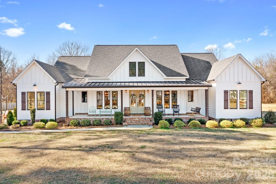 Exquisite Luxury Custom-Built Residence in the Highly Coveted North Lincoln School District

Welcome to a home where exceptional craftsmanship, thoughtful design, and modern comfort blend seamlessly. Built in 2021, this refined farmhouse-style residence features beautifully exposed beams in the vaulted living and dining areas, an elegant accent wall in the home office, White Oak 3/4" hardwood flooring throughout the main level, quartz countertops, and a meticulously curated open-concept layout.

The main level showcases four bedrooms, including an impressive primary suite enhanced by its own dedicated HVAC system for personalized comfort. A sophisticated split-floor plan provides three additional bedrooms, two full baths, and a stylish half bath—offering both functionality and elevated design.

The upper level features 695 sq ft of luxuriously finished bonus space with a full bath. Currently utilized as a bedroom, this private retreat is equipped with a Mitsubishi Electric climate-controlled HVAC system, making it an ideal space for guests, a media lounge, executive office, or creative studio.

Every detail throughout the home has been impeccably considered—leathered granite countertops in all full baths, tiled flooring and shower surrounds, a WiFi-enabled double oven (with a convection top oven), a separate microwave, an expansive 4-seat island, and a dining area generously sized to accommodate an 8-seat table. A tankless water heater provides endless comfort for family and guests alike.

Step outside and unwind in your private resort-style oasis, complete with a large in-ground pool, covered rear porch, outdoor kitchen, and outdoor fireplace—an unparalleled environment for luxurious year-round enjoyment.

With over 251 feet of road frontage, an extra-large side and rear yard ideal for parking, entertaining, or future expansion—the options are endless—as well as parking for five vehicles with a 3-car attached and 2-car detached garage, all with the added benefit of no HOA dues.
The detached two-car garage will be finished with the same exquisite level of detail as the home, featuring black garage doors and black-framed windows.

A residence of remarkable beauty and uncompromising quality, crafted for those who appreciate the finest in comfort, style, and elevated living.