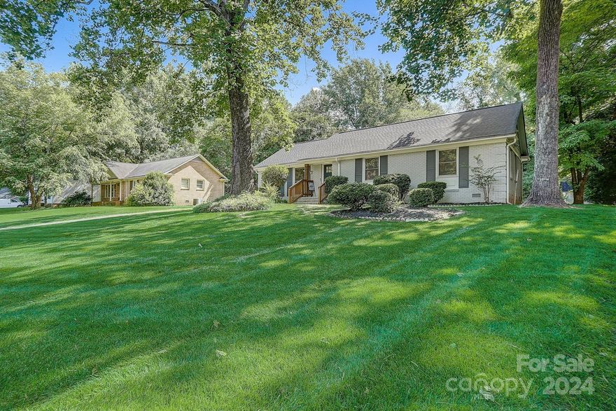 Welcome to this updated ranch home in the desirable Hampshire Hills! W/ 4 bedrooms and 2 bathrooms, this residence boasts a well-maintained yard and freshly painted brick exterior, enhancing its curb appeal. Enjoy beautiful hardwood floors and large windows that fill the open-concept floor plan with natural light. The modern kitchen is a chef's delight, equipped with stainless steel appliances, quartz countertops, a stylish backsplash, shaker cabinets, a large island, and updated light fixtures. The spacious primary bedroom offers a serene retreat with an ensuite bathroom featuring dual vanities and a tiled walk-in shower! Three additional bedrooms provide ample space for guests, family, or flexible use. Outside, the large back deck overlooks meticulously maintained fescue grass and a tree-lined yard, ensuring privacy. Located just a short drive from Uptown Charlotte, this home offers the perfect blend of suburban tranquility and urban convenience.