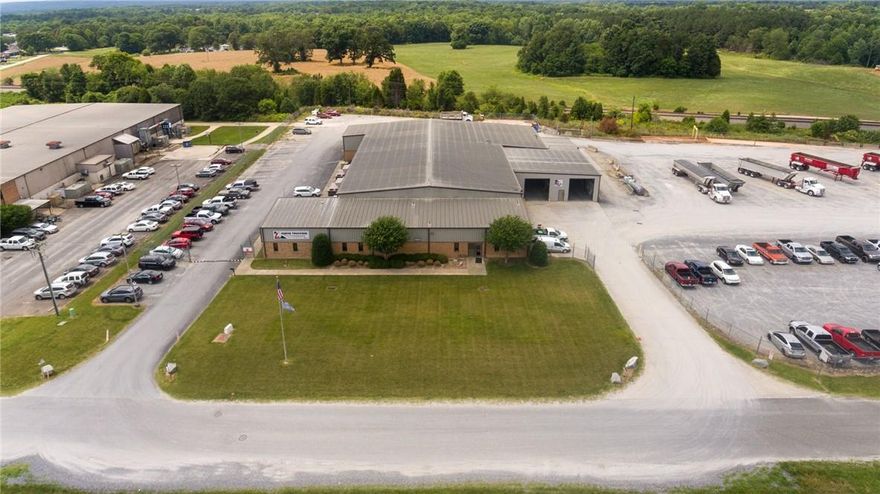 Light Industrial building located in Grover NC now available.  4800+/- sq ft of office space with an additional 17,800 sq ft of shop floor (Shop floor is heated/cooled)  This property is located on NC HWY 29, 1.5 miles from I85.  Property can be accessed most conveniently from I85 exits 4 and 2.
Some of the unique features of this building include: a 2-ton bridge crane in one bay with 12’ under the hook. Columns for an additional bridge crane have been installed in another bay.  All bridge crane columns could be removed and are not part of the buildings support structure.
6 acres fenced in.
Mechanical room includes a 50 Hp air compressor with air storage tank and air dryer. Building includes three (3) 14’ wide and two (2) 12’ wide roll-up doors.