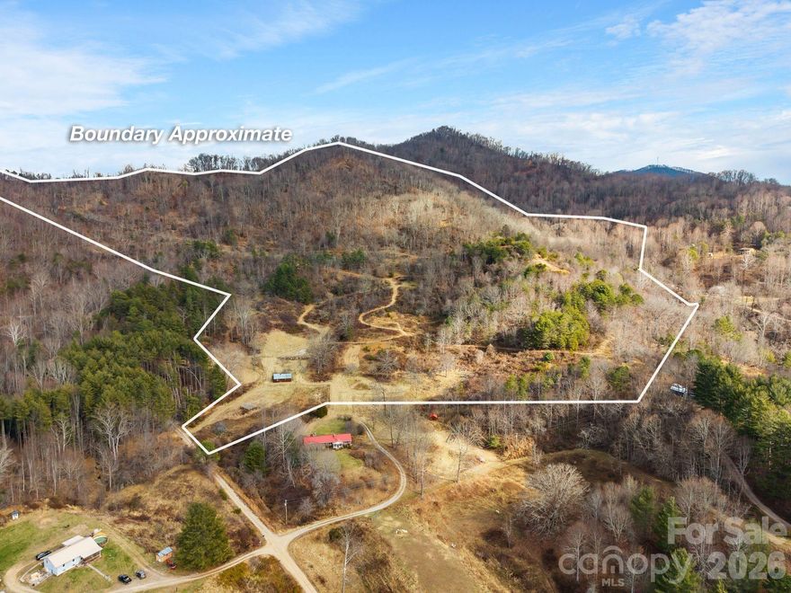 Breathtaking views from multiple potential homesites abound with this once in a lifetime opportunity! Come experience this large private mountain tract in Haywood County, NC. Comprising two separate, adjoining parcels, this approximately 94 +/- acre paradise is ready for its new steward! Wildlife, orchards, and pastures are all part of the peaceful paradise that you can call your own. Three roads traverse the property at different elevations, gently ascending through the lower pastures and up to a central level area where they meet, welcoming you with stunning views. These roads provide access to numerous relatively level building sites. Towards the western side of the land there is a nice level area with great views. The upper road from there goes to the top of the mountain, peaking above 3,500ft in elevation where you’ll find numerous older growth trees and exquisite mountain views!  Head on the eastern roads and discover an amazing level finger knoll that has unparalleled long range mountain views. Beyond the finger knoll, near the east side boundary there is a large wooded level area that would be a wonderful peaceful homesite. Almost all areas of the property are accessible by the roads in place. There are several acres of pasture at the bottom of the land with more that could be reclaimed. The entire property is fenced with metal stakes and wire. Small seasonal creeks and springs on the property add even more charm. There is an older homestead building on property that has no value, no septic permit was found with the county. This property is perfect for a private mountain estate, family compound, hunting retreat or for development. Property is part of an estate sale and is being sold as is.