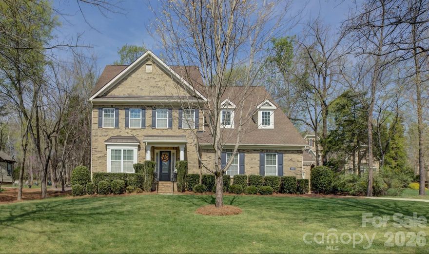 Nestled in the sought-after Chapel Cove community bordering beautiful Lake Wylie, this stunning home is sure to impress with its elegant design and thoughtful layout. A grand two-story foyer welcomes you in, flanked by a formal dining room with a coffered ceiling, while a convenient pass-through butler’s pantry leads to the gourmet kitchen featuring a gas cooktop, double ovens, abundant maple cabinetry, and an oversized granite-topped island with a double-bay sink. The open-concept floor plan seamlessly connects the kitchen, breakfast area, and living room, creating the perfect space for everyday living and entertaining, with the breakfast area opening to a covered deck overlooking a large, private wooded backyard. A main-level guest suite with a full bath offers comfort and convenience for visitors, while upstairs, the luxurious primary suite boasts a coffered ceiling, dual vanities, a corner soaking tub, a glass-enclosed shower, and a custom-designed closet. Bedroom three enjoys its own private bath, while bedrooms four and five share a Jack-and-Jill bath, and a spacious bonus room provides the ideal setting for relaxation or entertainment. Completing the home is a three-car garage, including a two-car side-load and a separate one-car bay perfect for a golf cart or hobby space. Residents of Chapel Cove enjoy exceptional amenities, including a lakefront clubhouse, resort-style pool, fitness center, tennis courts, playground, and scenic walking trails, all just moments from the shores of Lake Wylie.