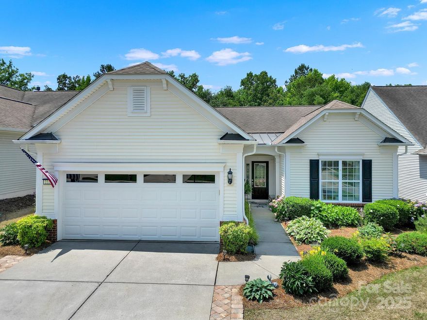 BEAUTIFUL updated & upgraded home in Sun City Carolina Lakes on private wooded homesite! Be prepared for the WOW factor! An elegant tile foyer welcomes you home as you step into the open living room featuring a gas log fireplace. A breakfast bar separates the living room from the STUNNING kitchen featuring granite countertops, marble backsplash, white painted cabinets w/under-cabinet lighting, & stainless-steel appliances. The dining area flows into the light-filled sunroom, perfect for entertaining. Glass French doors open to a home office or hobby room. The primary suite w/tray ceiling overlooks views of the tree lined back yard & offers an ensuite bath w/dual sink marble vanity, tile flooring, seamless walk-in shower & spacious closet. A generous guest room w/access to a full bath sits at the front of the home. The jewel of this home is the covered paver patio surrounded by lush greenery & custom landscaping, creating a tranquil oasis. Don’t miss Sun City’s resort-style amenities!