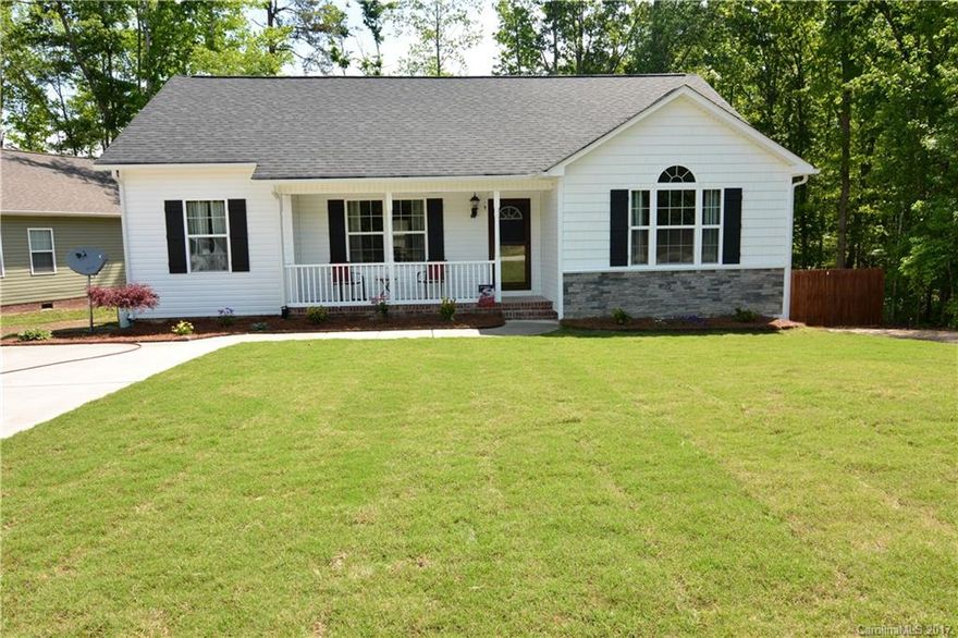 Tranquil three bedroom ranch home in the heart of Clover.  The many home features include a cathedral ceiling in the great room with large screen television, split floor plan with separate master suite, fenced backyard that includes an out building with electricity, deck overlooking the back yard, sodded front yard.  All within a short walk to shopping.  The home features privacy bordering undeveloped property to one side and across the street.  All this within the Clover school district!