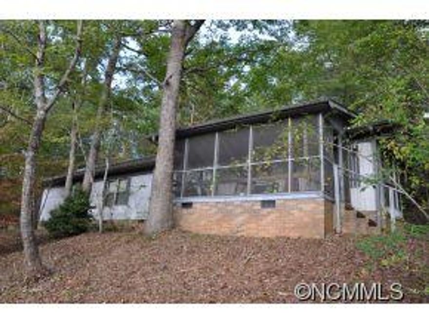 Enjoy privacy and beautiful scenery from this easily accessible and affordable single wide in Lake Lure.  Just a few minutes from the resort in a great location this home offers good living at a great price!