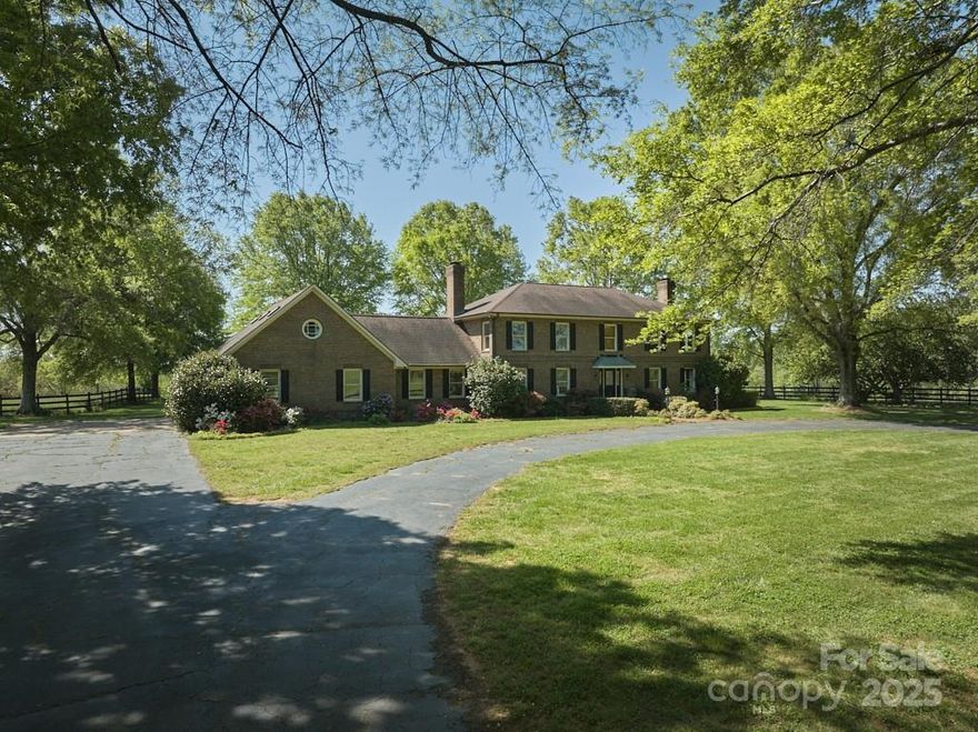 An exceptional opportunity to acquire a pristine 48.51-acre estate situated within the heart of one of Polk County’s premier equestrian neighborhoods. This special estate features level to rolling fields, featuring three-board fencing, tree-lined driveway, and a spacious ~5,500 square-foot brick home, which includes an apartment over the garage. The property is eligible to join CETA trails.
Renovations include a newly renovated kitchen and bathrooms. Three wood-burning fireplaces enhance the ambiance. The downstairs area features two additional bonus rooms, living room, a wet bar, and a full bathroom. An expansive in-ground pool further enhances the property’s allure.
A small stream is located near the eastern line. The land has level-to-gently rolling terrain. Multiple building sites are available for guest home, barns, and/or arenas. Tryon International Equestrian Center is a short 15 minute drive away.