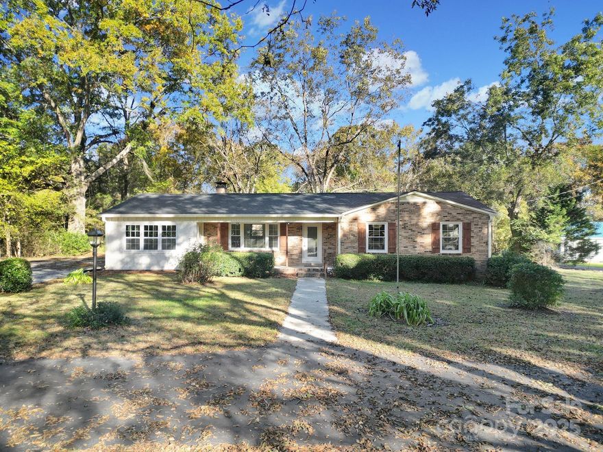 Beautifully restored, this charming 70's full brick home is move-in ready.  Maintenance has been brought up-to-date with a new roof, septic and deck.  Step inside to find refinished white oak floors, built in bookcases in the living room, a refreshed fireplace in the eat in kitchen, a pleasant sunny family room with brick and cypress accent walls and beamed ceiling, plus a totally rebuilt primary bath.  The home is shaded by a majestic oak; the large yard provides room for numerous trees and shrubs; fruit bearing pecan, roses, and hydrangea.  Back on the market with additional upgrades ready for your inspection.