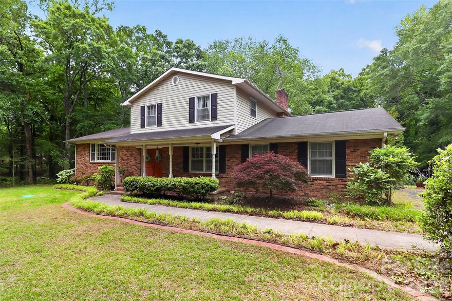 Tucked away on a beautiful wooded 4.5-acre tract just across the state line from Ballantyne, this rare Indian Land property offers endless potential in an unbeatable location. Surrounded by mature trees and natural privacy, the classic two-story home features 4 bedrooms and 3 full bathrooms with a traditional layout including formal living and dining rooms, a spacious family room, and hardwood floors throughout much of the home.

Full of character and charm, the home remains in its original condition and is ready for updates and renovation, making it an incredible opportunity for investors, renovators, or buyers looking to create their dream estate. The expansive acreage also provides a spectacular setting for building a custom luxury estate, with plenty of room for a gated entrance, pool, guest house, gardens, or additional outdoor living spaces.

Enjoy the peaceful feel of country living while being only minutes from Ballantyne’s shopping, dining, and conveniences. Hard-to-find acreage, mature trees, and unlimited possibilities make this a truly special opportunity in rapidly growing Indian Land.

Home has good bones but needs extensive updating!  Value is largely in the acreage.