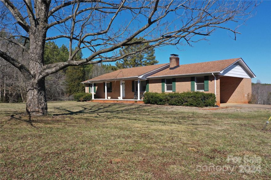This brick ranch home with a walkout, partially finished basement is situated at the front of 23+/- acres with tons of potential for farming, hunting, or pasture. Seller has begun to clear parts of the property allowing for future pasture or farming potential. Crooked Run Creek runs the back of the property and provides a watering source for farming or wildlife. This well maintained home has three bedrooms and two baths with kitchen, large laundry/mud room, living room and two car carport. Electric heat and air, wood burning fireplace, county water and a working well are available. The Master suite has a private bath with walk in ceramic tile shower. Some recent improvements include flooring, paint, septic tank, deck, and partial open concept. The basement is full of potential and includes a bathroom, fireplace with wood stove, second washer/dryer, electric oven and large concrete patio. Additional structures on the property include a three stall tractor shed and storage container.