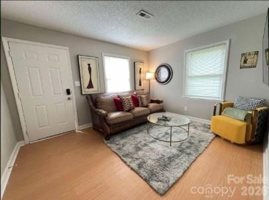 Freshly painted and furnished, full-brick duplex in the sought after Grier Heights, this charming two-unit property features two 2-bedroom, 1-bathroom homes, each offering the perfect blend of comfort and style with an inviting, cozy atmosphere throughout. Each unit spans 635 square feet and includes a living area, kitchen, two bedrooms, and one full bathroom. The open-concept living area features comfortable seating with a plush sofa and armchairs, making it an ideal space for relaxing or entertaining. The living room flows seamlessly into the dining area, where a stylish dining table provides a welcoming setting for meals. The fully equipped kitchen is compact yet efficient, featuring modern appliances, sleek countertops, and ample cabinetry for storage—perfect for both everyday use and entertaining. The primary bedroom serves as a peaceful retreat with a comfortable queen-sized bed, soft linens, and a spacious closet. The second bedroom is also well-sized and includes a cozy bed and furniture, making it ideal for a guest room, home office room. The bathroom is modern and functional, featuring a beautiful vanity, a well-lit mirror, and a shower/tub combination designed for both comfort and convenience. This home is furnished, with tasteful decor and quality pieces that create a warm and inviting atmosphere. Every room is designed for both functionality and relaxation, ensuring that this house is not only comfortable but also a stylish and well-equipped space to call home.