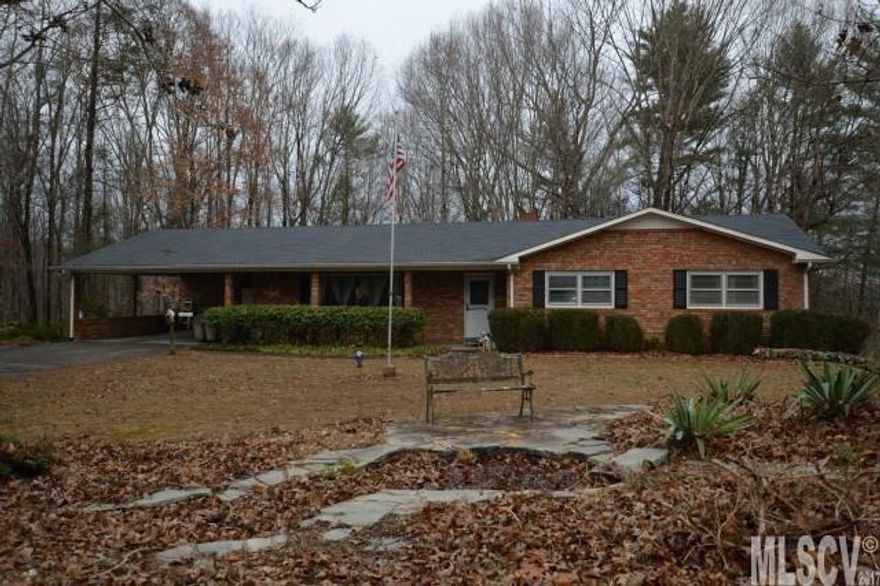 This very spacious brick ranch offers one level living and is situated on one acre with a screened porch that overlooks a private, wooded back yard. There is a cozy den with beamed ceiling, hardwood floors, and fireplace, and a huge living or dining room that the seller is using as a formal dining room which can easily and comfortably seat 12. The bedrooms are all a generous size. The laundry room is conveniently located just off the kitchen and the screened porch and open deck are accessed from the eat-in kitchen. Downstairs you will find an oversized den/recreation room, as well as an extra room for an office, a half bath, a workshop area with single garage bay, and an additional storage room. This home offers lots of living space at this price point and plenty of parking space as well. Good value!