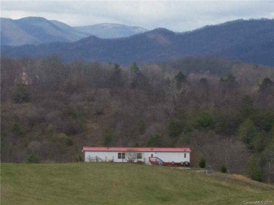 Your very own paradise sitting on a plateau surrounded by awesome views of gorgeous mountain ranges & open vistas. This 2BD/2BA is a bargain priced to buy. Very well maintained. Central air conditioning, 2 Master bedrooms. All on one level. Fruit trees, native landscaping, a walking track around this home - all add to the charm. Covered porch, 6x16 back deck & circle drive for easy access. 1.5 acres. Privacy yet close to all of Haywood County's amenities. 15 min to Waynesville, 30 to Asheville.