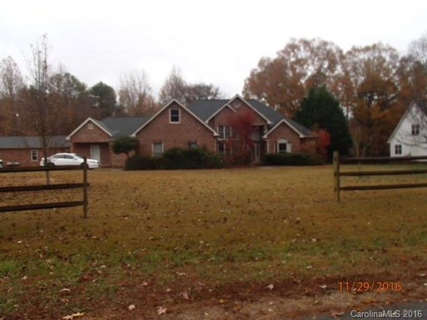 All brick ranch with a bonus room over garage. 2nd living quarters with a separate entry with full kitchen and laundry. 1 car carport for the guest quarters and a 2 car garage for the main house. Extensive decking on the back with above ground pool and fenced yard. Sun room and office. Fireplace in Great Room. Shop area in the garage.  Detached storage building. House needs some cosmetics but priced accordingly and has great potential. Spacious 1.35 acre lot.