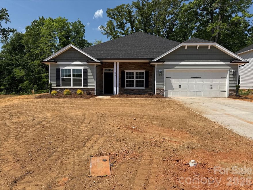 This beautifully designed open-concept home seamlessly connects the kitchen, dining area, and family room, creating a bright and inviting space ideal for both everyday living and entertaining.

The well-appointed kitchen features modern appliances, a large center island, generous counter space, and ample cabinetry for storage and functionality. Just off the kitchen, the formal dining room showcases an elegant tray ceiling, adding a touch of architectural charm.

The private primary suite offers a relaxing retreat, complete with a spacious walk-in closet, tray ceiling with crown molding, dual vanity, and a stylish tiled 5-foot shower designed for comfort and convenience.

Three additional bedrooms provide flexible space for family, guests, a home office, or a hobby room, allowing the home to adapt to your lifestyle easily.

The 2100 floor plan also includes a two-car garage for convenient parking and storage, along with an attractive stone accent package that enhances the home’s curb appeal. Step outside to the rear concrete patio, perfect for relaxing evenings or gathering with friends and family.

With its smart layout, thoughtful details, and flexible living spaces, the 2100 floor plan offers a comfortable and stylish place to call home.