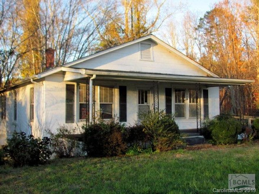 Investors and handy persons will love this one!  home on 1.69 acres possibly room to build a second home.  Ceiling needs repair in living room.  Tin ceilings on lower level, large kitchen with lots of cabinets. nice front porch, outbuilding and enclosed back porch. This property has so much potential will most likely need to be cash sale, needs repairs. One of the bedrooms was turned into a 2nd kitchen.  Large lot with so many possibilities.  Home being sold as is will need bank approval.