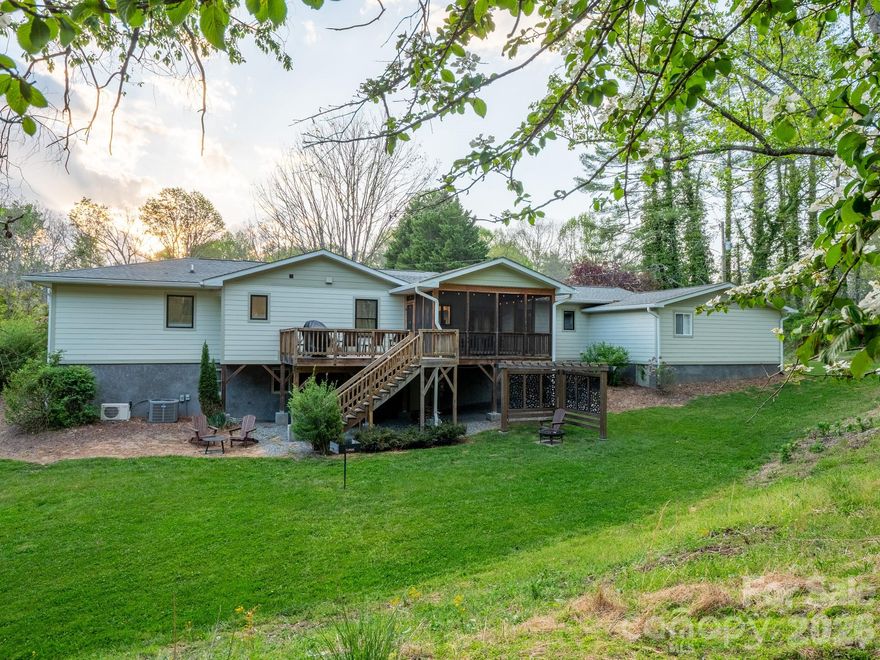 Welcome to 1048 Jenkins Valley Road, where you don’t have to choose between privacy, luxury, and convenience. This is the kind of place people come to Asheville hoping to find and rarely do. Tucked away on nearly 2 peaceful acres, yet only 15 minutes from downtown, it offers that hard to get balance of quiet mountain living with easy access to everything you love about the city.

From the moment you walk in, it’s clear this isn’t just a remodel, it’s a complete transformation. The home feels like new with a bright, open layout, vaulted ceilings, and three separate living areas. The kitchen is the heart of it all, featuring a massive quartz island imported from Spain, custom hardwood floors, and high end finishes that make it as functional as it is beautiful.

Every detail is intentional, from the tucked away laundry room to the thoughtfully designed tiled showers that add a bit of artistry to everyday living. Step outside, and it only gets better. The screened in porch is made for peaceful mornings and tranquil evenings, while the open deck looks out over a charming pole barn and a natural watering hole that regularly draws in local wildlife. This could be your own private slice of the mountains.

With nearly 2,000 square feet on the main level, the home offers 3 bedrooms and 2 1/2 bathrooms with easy, comfortable living all on one floor. Downstairs, you will find an additional living room along with three bonus rooms, giving you even more flexibility for guests, workspaces, or hobbies. The lower level is also plumbed for an additional 1 1/2 bathrooms, creating a great opportunity to expand and add your own personal touch.

Whether you’re dreaming of a homestead, exploring income potential, or simply want a turnkey escape, this property delivers. It is being offered fully furnished, with a well stocked kitchen ready for your first dinner party or a cosy night in. The flat, usable yard is perfect for gardening, gathering, or just enjoying the fresh mountain air.
The property is currently being used as a short-term rental.