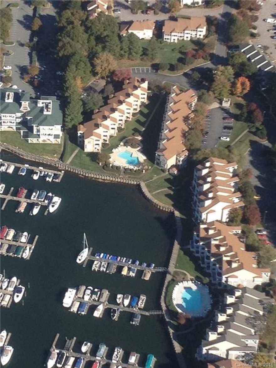 Ground floor lakefront condo with salt water pool.  New granite countertops, tile backsplash, paint throughout, carpet in both bedrooms, crown molding.  Steps from the pool and marina.  Main channel sunset views from your patio.  Washer/Dryer/Refrigerator remain!  Cable, Internet, and Water included in HOA dues!  Just pay electricity!