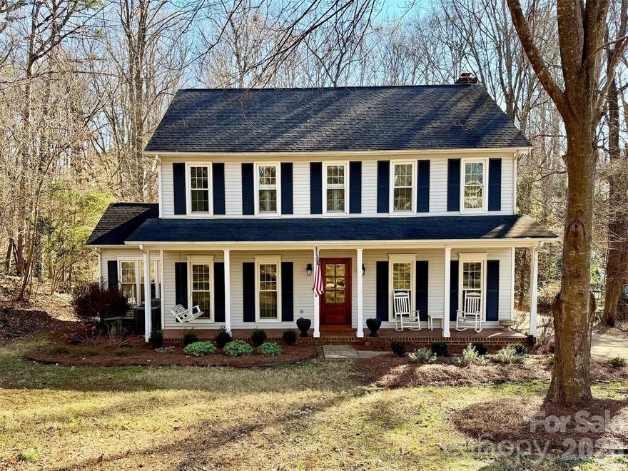 This beautifully updated 4-bedroom home in the highly desirable Old Orchard neighborhood of Fort Mill sits on an expansive .68-acre wooded lot with extensive privacy, a spacious deck, and an inviting front porch complete with rocking chairs and a charming swing. Inside, you’ll find hardwood floors throughout the main level and all bedrooms, fresh interior paint and fixtures. Thoughtfully designed living spaces including a formal sitting room and flexible front room ideal for a home office. The renovated kitchen is a true highlight, featuring updated appliances, a generous eat-in area, two pantries, and an open layout to the family room—perfect for everyday living and entertaining. Upstairs, the primary suite offers a tray ceiling, and a walk-in closet, while three additional bedrooms also feature hardwood flooring. The spacious bonus room includes built-ins, new carpet, walk-in attic access, and a closet, making it an ideal fifth bedroom or multi-purpose space. Additional custom built-ins in the downstairs sitting room and a beautifully designed drop zone add both character and function. With fully updated flooring, a new HVAC system, and a large private lot, this move-in-ready home offers comfort, style, and exceptional space both inside and out. Way too much to list easy to show set your appointment now.